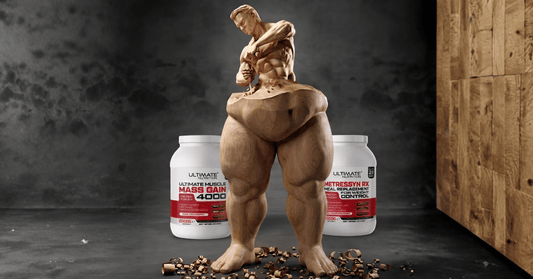 A wooden sculpture of a muscular man carving his own upper body out of a bulky base. In the background, two white tubs of Ultimate Nutrition supplements are displayed, Ultimate Muscle Mass Gain 4000 on the left and Metressyn RX Meal Replacement for Weight
