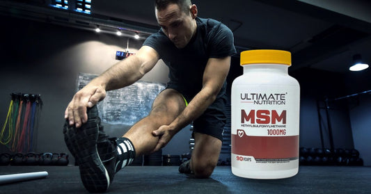 athlete stretching on a gym floor beside an ultimate nutrition msm 1000mg supplement to illustrate what research shows about msm for joint health for the article msm for joint health what the research shows
